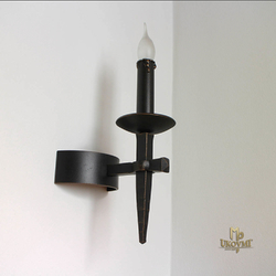 A historical side-wall lighting ANTIK  forged one-candle lamp made in UKOVMI