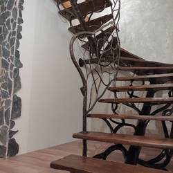 Forged staircase with remarkable railing, completed with wood  interior design