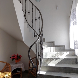 Helical staircase railing in afamily home  forged railing