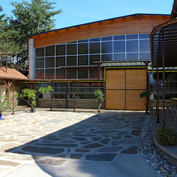 A shelter and a sliding door - an entrance to a riding hall