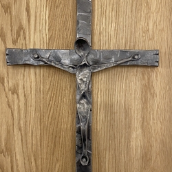 Christian symbol - wrought iron cross on the wall