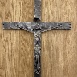 Christian symbol - wrought iron cross on the wall Christian symbol - wrought iron cross on the wall