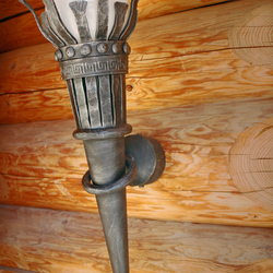 The luxurious Torch light fixture recalls historical times when light was brought by fire