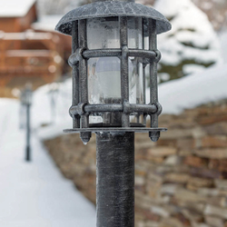 A garden hand forged lamp with a logo UKOVMI