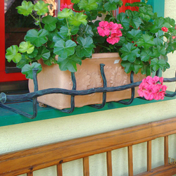 Kovaný držák květináčů vzor Babička v zelené patině - zábrana na truhlíky v lidovém stylu