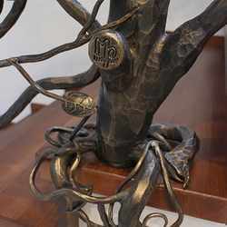 Detail of a luxury railing forged as an apple tree with a UKOVMI seal Detail of a luxury railing forged as an apple tree with a UKOVMI seal