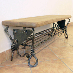 A hand wrought iron shoe rack of a unique design.