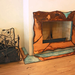 A copper wrought iron fireplace + a wrought iron firewood rack