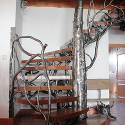 A luxury staircase with railing hand-forged as a winter tree - artistic staircase