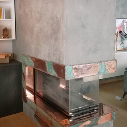 A copper wrought iron fireplace 