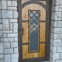 A wrought iron entrance door with wood