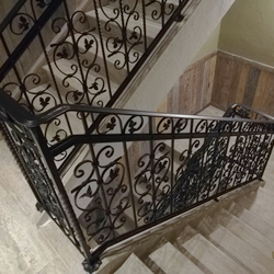 A wrought-iron multistorey railing - interior railing in an apartment hotel