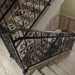 A wrought-iron multistorey railing - interior railing in an apartment hotel A wrought-iron multistorey railing - interior railing in an apartment hotel