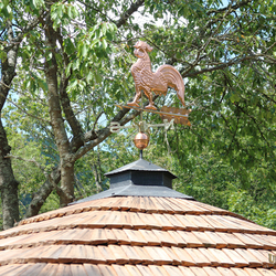 Copper rooster on a forged roof – summer gazebo near the family house