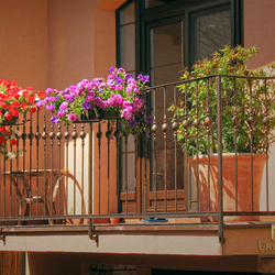 Kované zábradlí s držáky květin na balkoně rodinného domu
