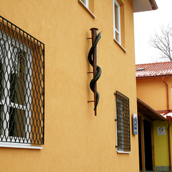 Wrought-iron works at the medical center in Levoa  grilles for doors, windows, and forged medical symbols