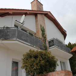 A modern wrought iron railing with a chain - exterior railings