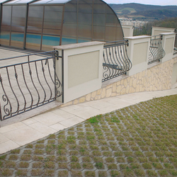 A wrought iron railing on a terrace