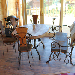  Hand-wrought iron dining table in a combination with oak wood, wrought iron chairs and a leather upholstered bench