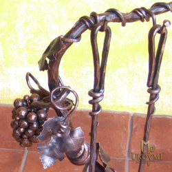 A forged grapevine detail on fireplace tools