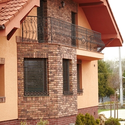 Balcony railings and forged flower pot holders on the windows