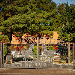 A wrought iron entrance gate with the Nature Park logo