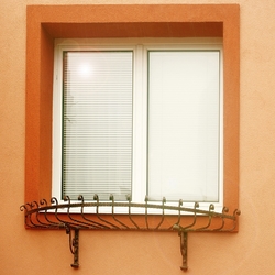 Kovaný držák květů na okně rodinného domu - okenní zábrana na truhlíky