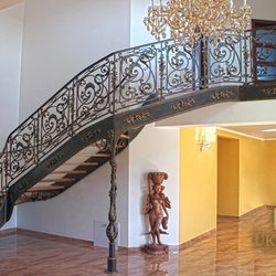 A wrought iron staircase with an exceptional interior railing