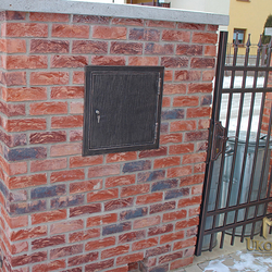 A wrought iron post box