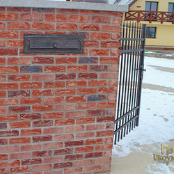 A wrought iron post box