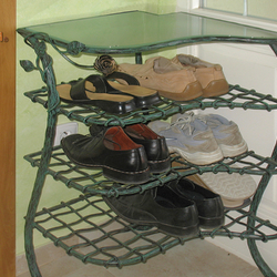 A wrought iron shoe-rack