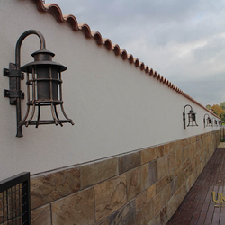 A wrought iron lamp with a shade - luxury lights