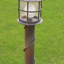 A wrought iron garden lamp with glass