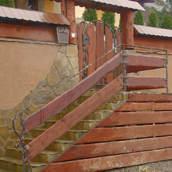 A wrought iron railing with wood