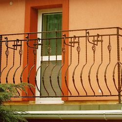 An exterior wrought iron balcony railing