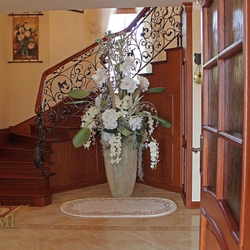 A wrought iron railing with a wooden handrail A wrought iron railing with a wooden handrail