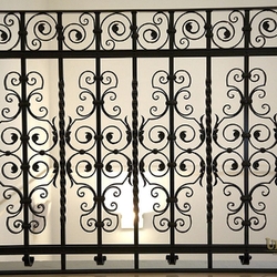 A wrought iron railing in a historical building from the 15th century