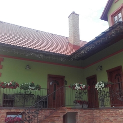 Ansicht eines Einfamilienhauses mit einem geschmiedeten Überdach und Geländer mit Eichenmuster, hergestellt von UKOVMI