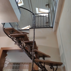 Forged interior staircase with handrail - detailed view of the attic entrance