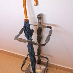 A wrought iron umbrella holder