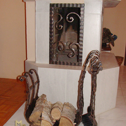 A wrought iron firewood rack with fireplace tools A wrought iron firewood rack with fireplace tools