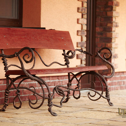 A rest on a porch in a wrought iron style