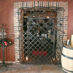 A wrought iron grille and accessorier for a wine cellar