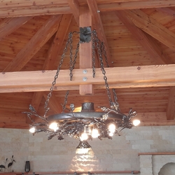 Luxurious DUB hanging chandelier - a hand-forged lamp in the gazebo of a family house