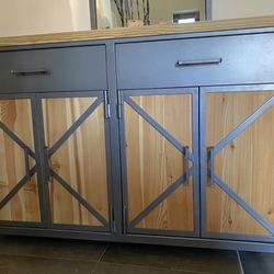 Wrought iron handles on the chest of drawers in the entrance hall of a family house - forged furniture Wrought iron handles on the chest of drawers in the entrance hall of a family house - forged furniture