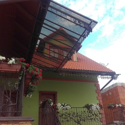 Wrought iron roofing of balconies of a family house