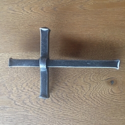 A wrought wall cross - religious objects