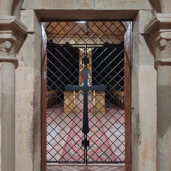 A wrought iron grille with a cross in the Roman Catholic church from the 13th century near Kežmarok - Slovakia A wrought iron grille with a cross in the Roman Catholic church from the 13th century near Kežmarok - Slovakia