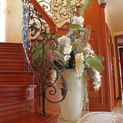 A wrought iron railing with a wooden handrail A wrought iron railing with a wooden handrail